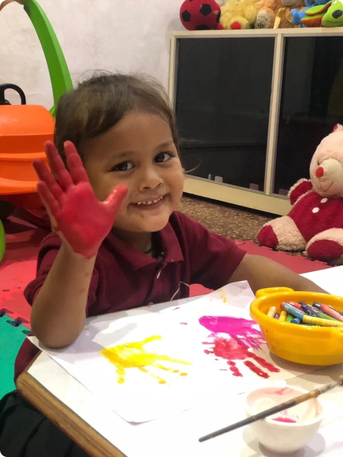 A child playing with toys at Shanti Niketan