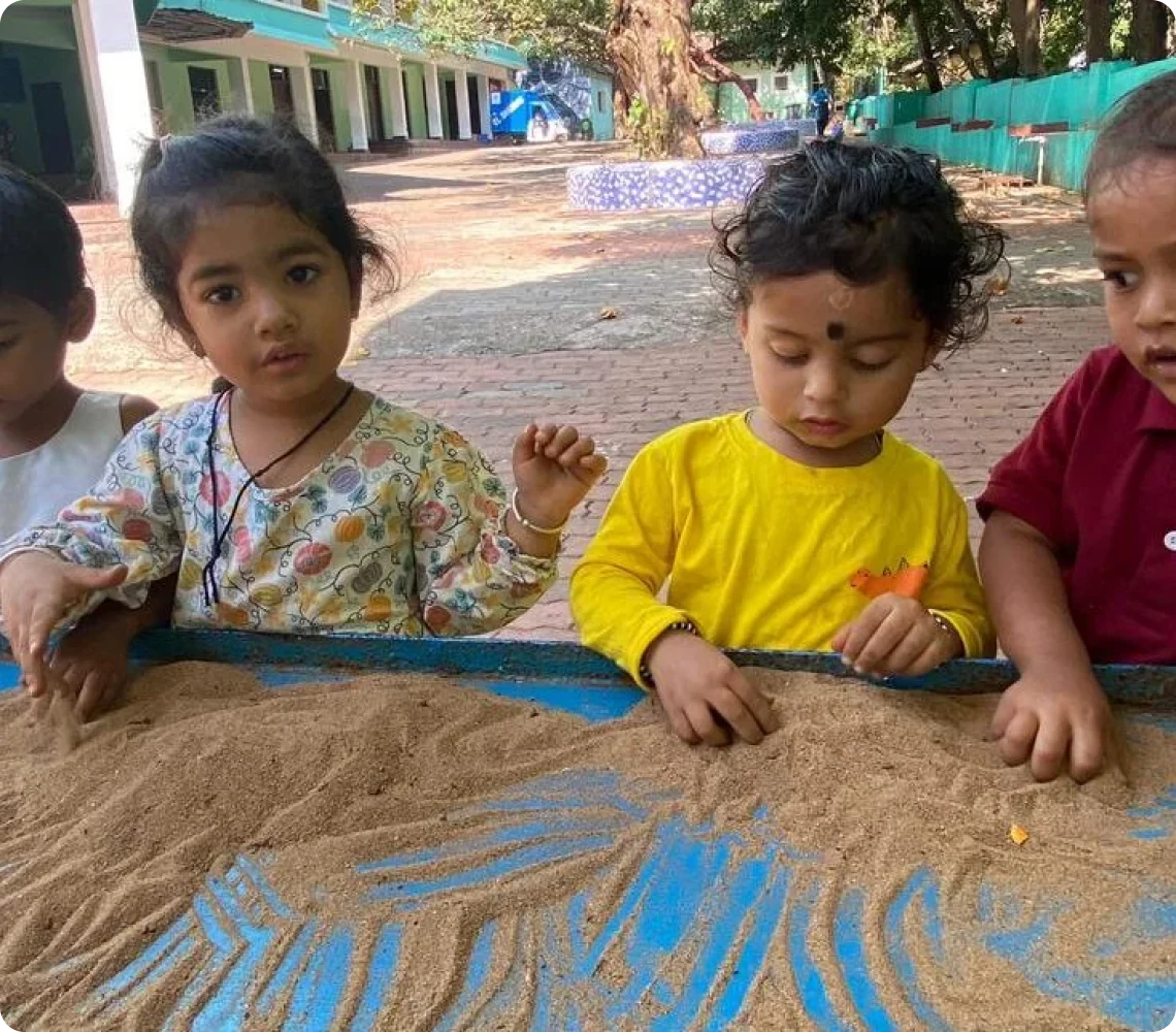 Children playing in the sand pit at Shanti Niketan